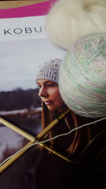 Les laines Skinny Single de Hedgehog Fibres coloris Down by the river et Mohair Luxe de Yarn blanche prêtes pour être tricotées sur les aiguilles circulaires Addi bambou en bonnet Kobuk de la créatrice Caitlin Hunter de Boyland Knitworks par McLovin.